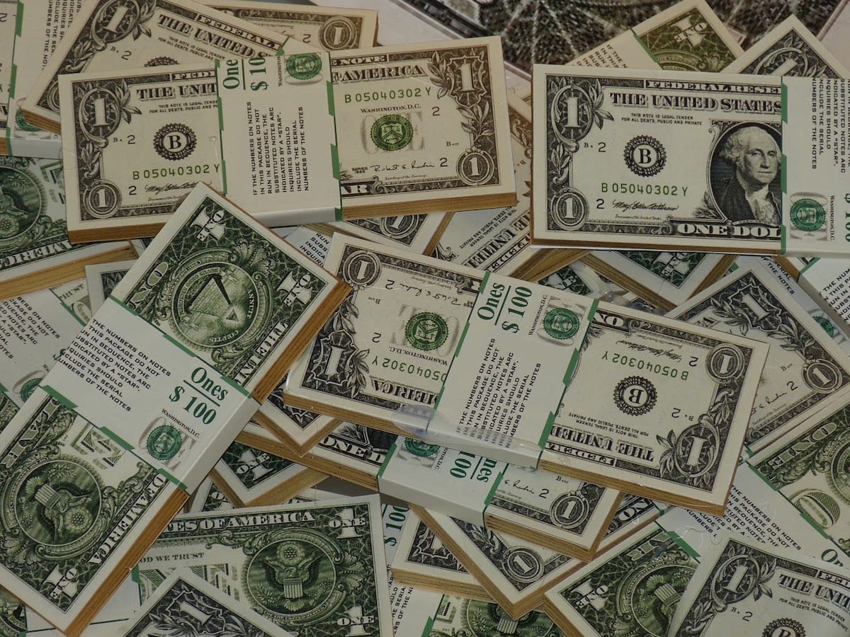 Stacks of fresh one-dollar bills that could be used to fund an in-person coding bootcamp.