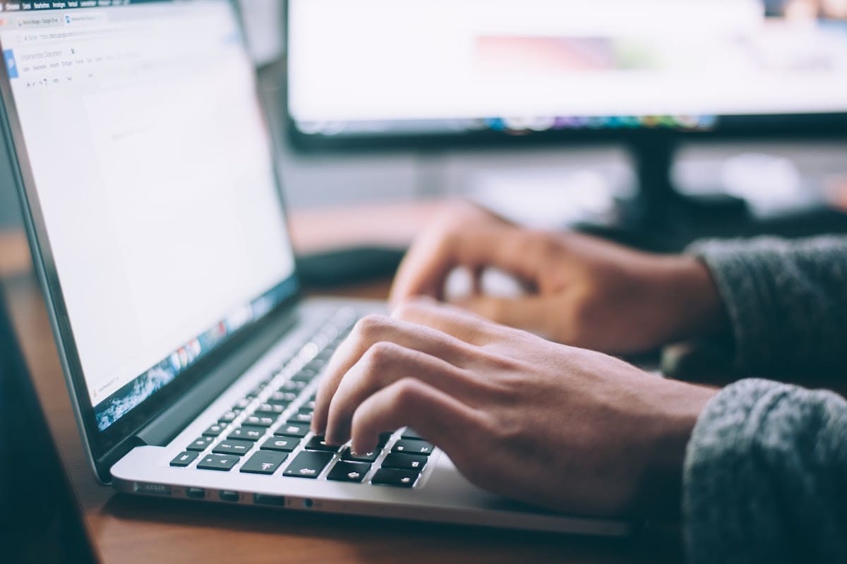  A person typing on a computer.