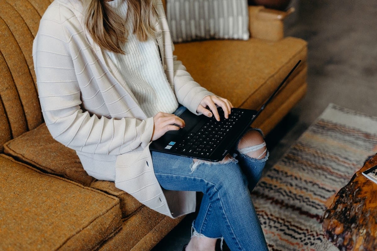 Image of a woman working on a laptop.
