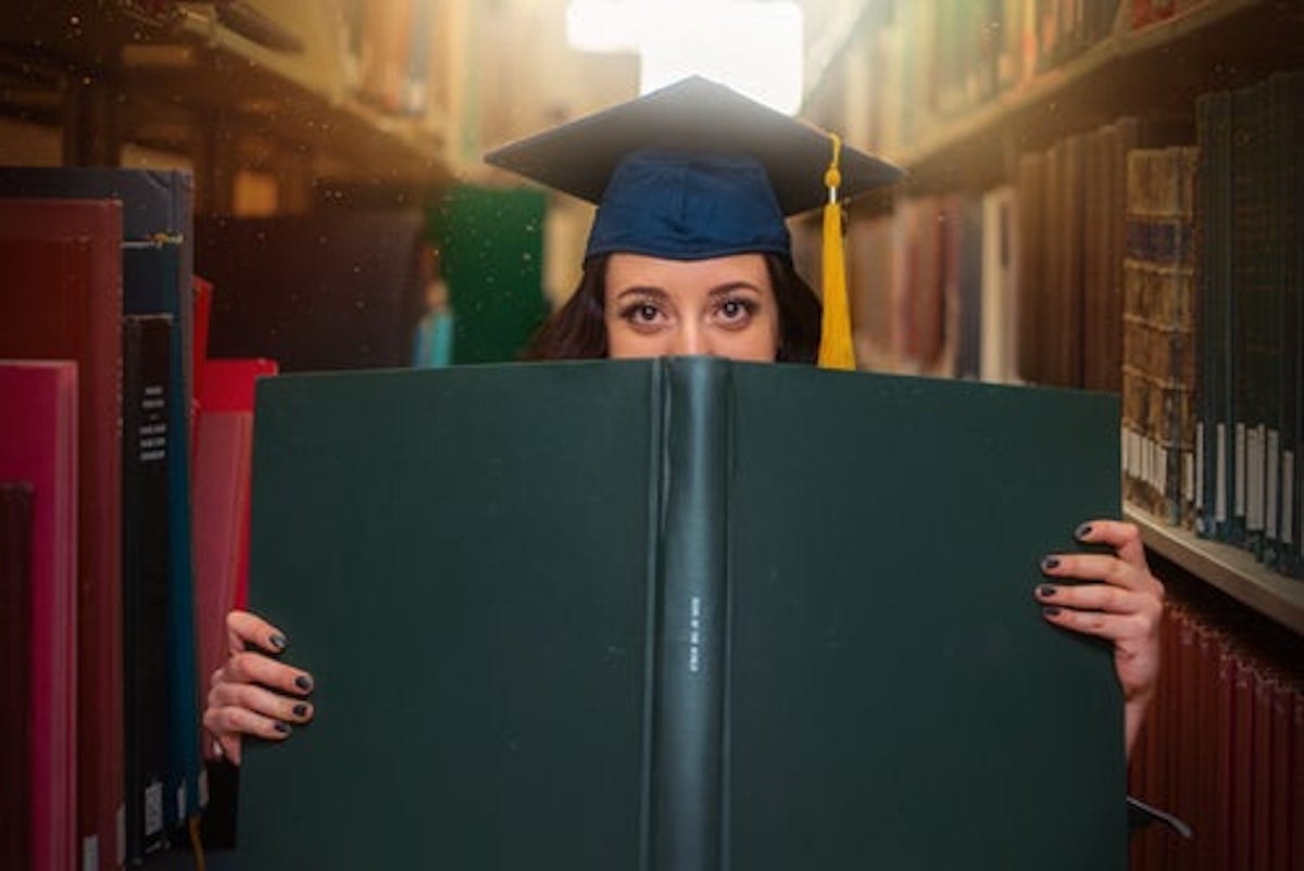 "Woman holding book”