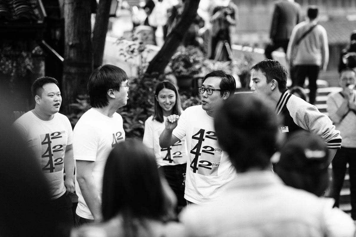 Grayscale photography of a man talking