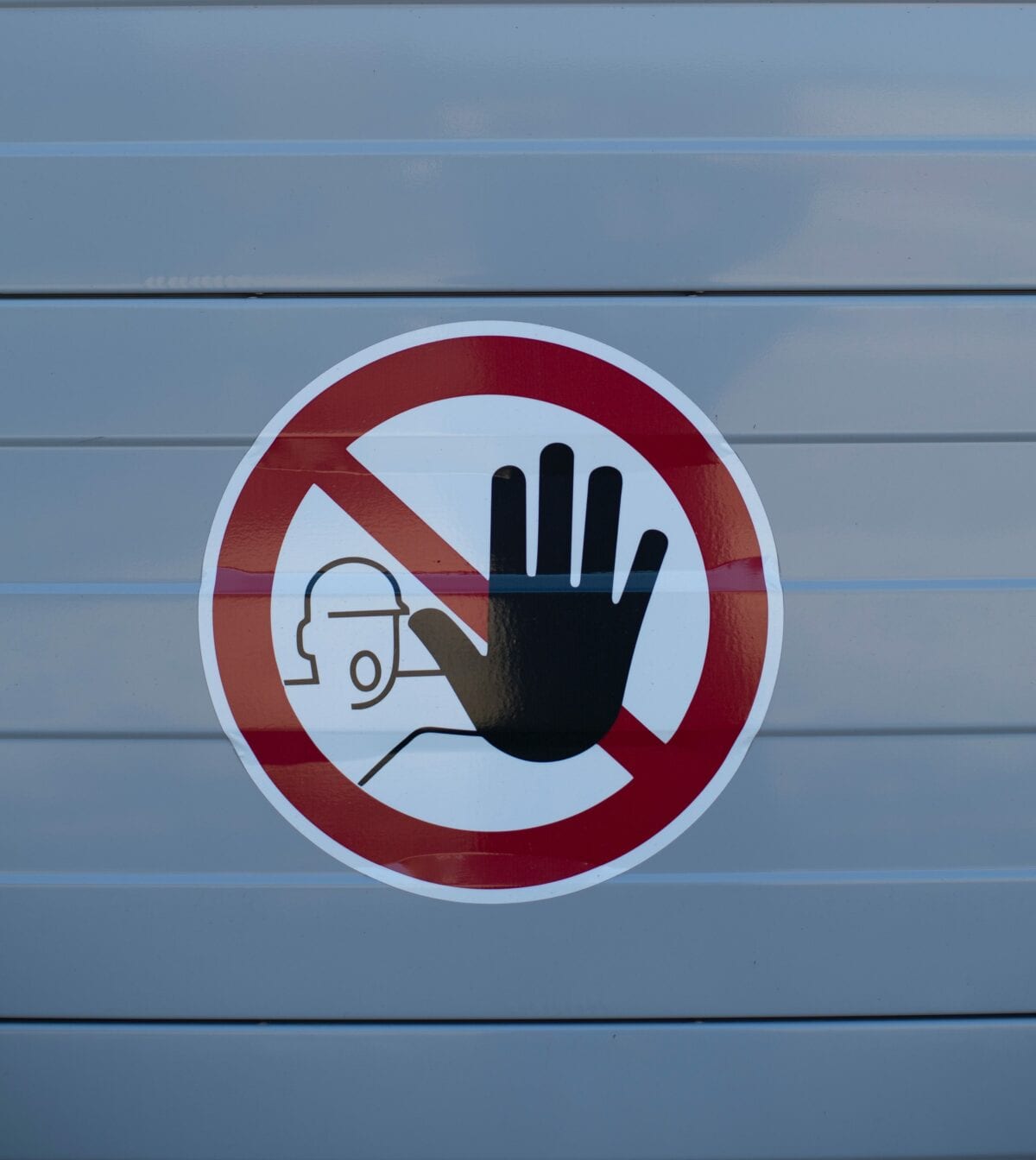 Sign displaying a hand indicating to stop.