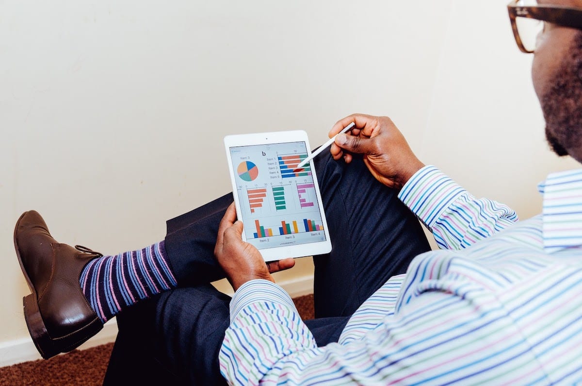 A person sitting and using a tablet. 