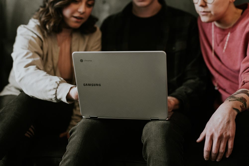 people gathered around a computer 