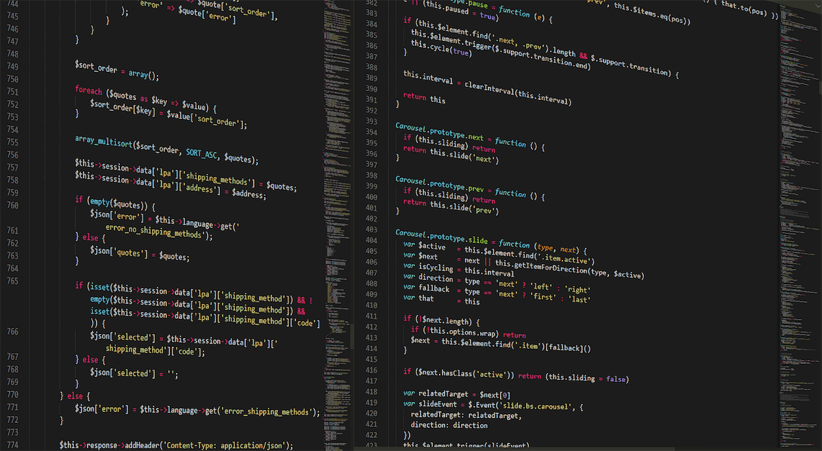 Lines of code on two computer screens.
