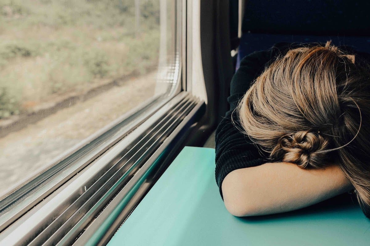 Sleeping woman next to window