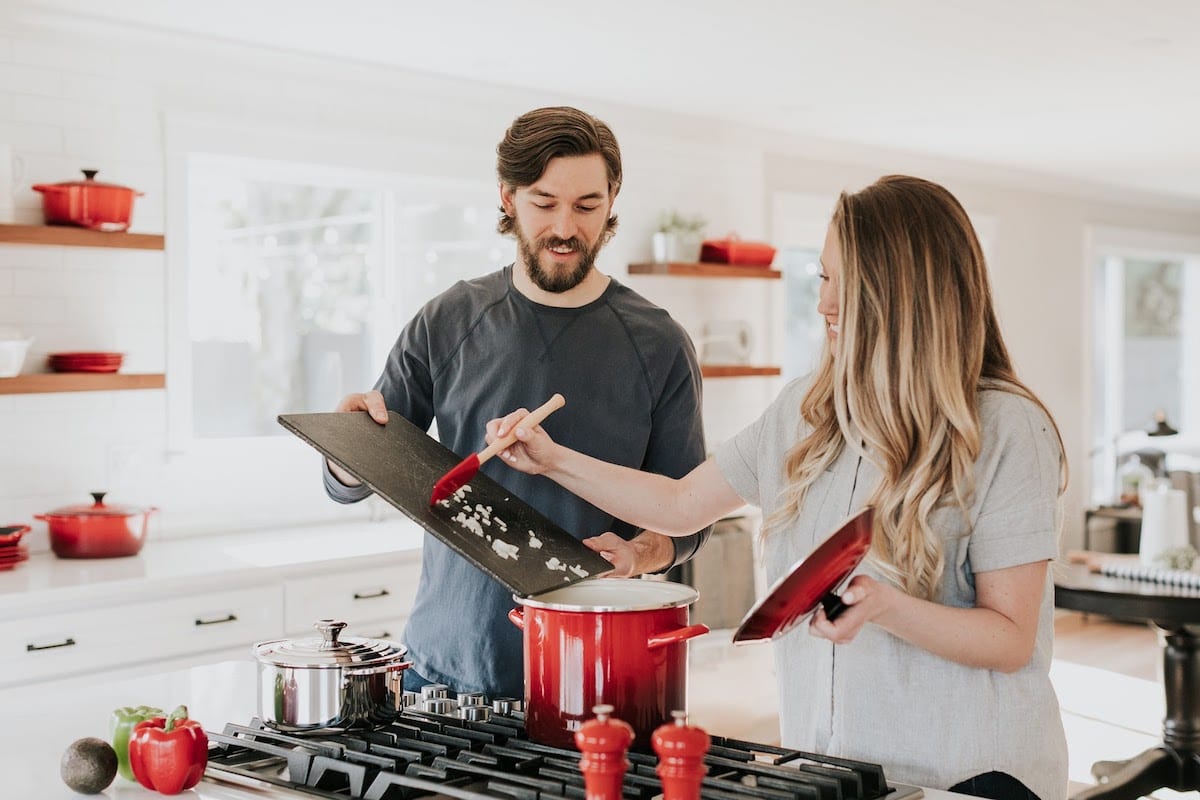 A man and a woman cooking dinner after attending the USC Viterbi data analytics bootcamp.