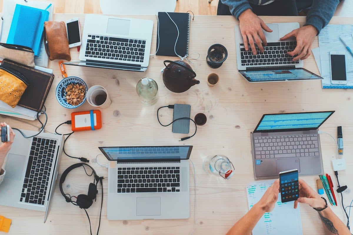 People coding PHP around a table. 