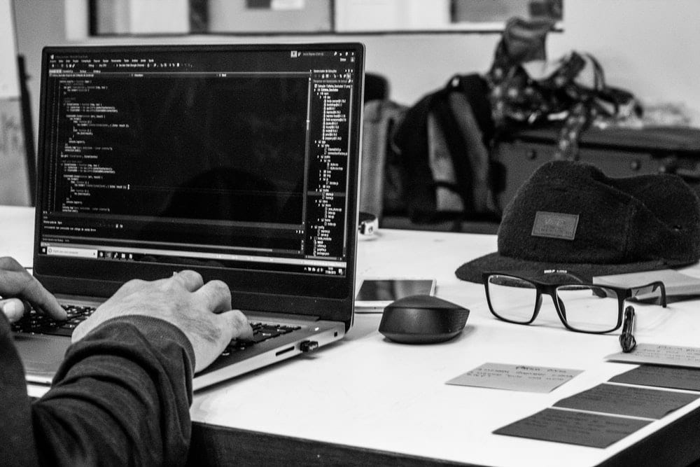  Man coding on a laptop. 