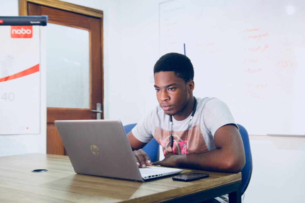 man sitting at computer