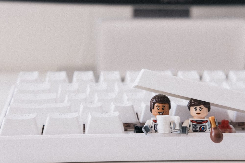  Figurines poking out of a keyboard. 