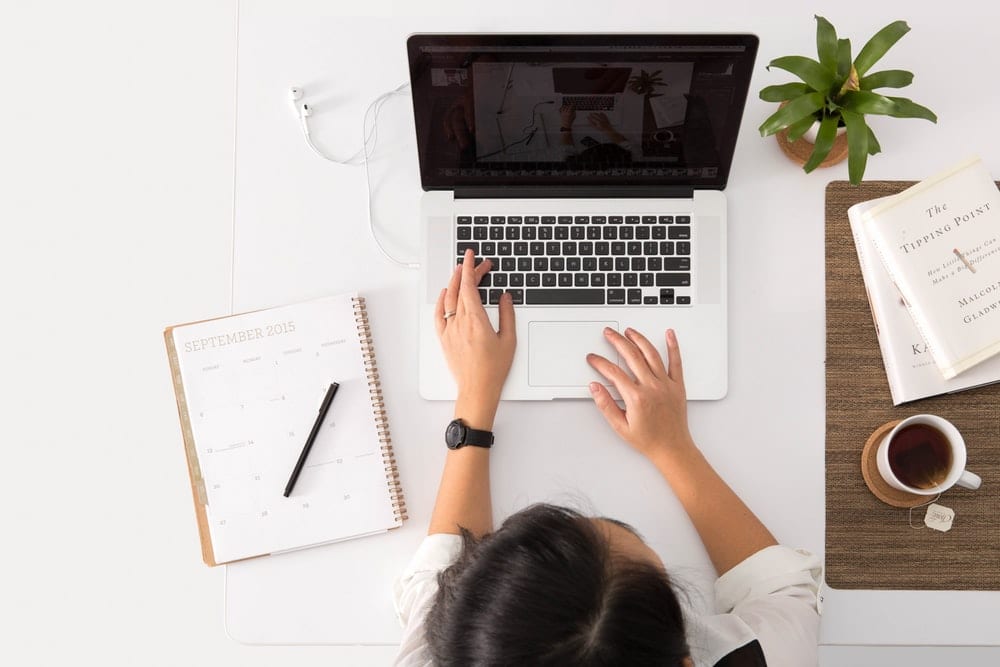  Woman writing on a laptop. 