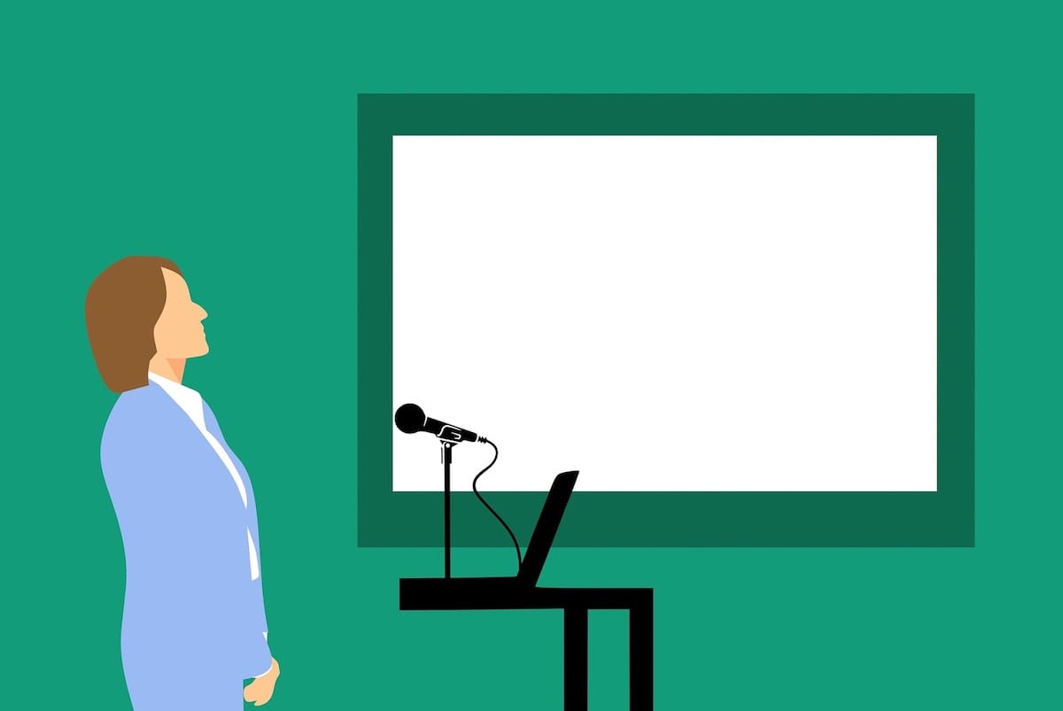 A cartoon depiction of a Rice University bootcamp instructor standing in front of a microphone and a laptop.