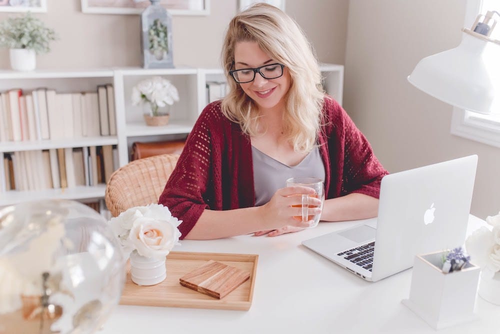 A woman working remotely on a laptop from a home office.