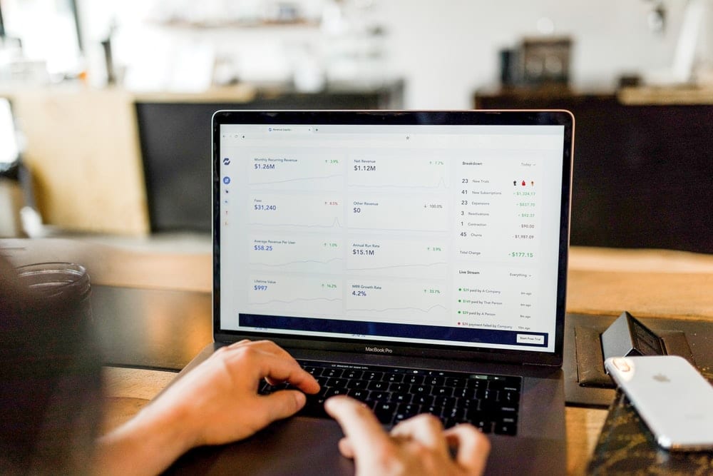 Man looking at figures on a computer.