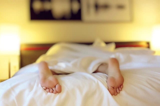 The feet of a person laying in bed