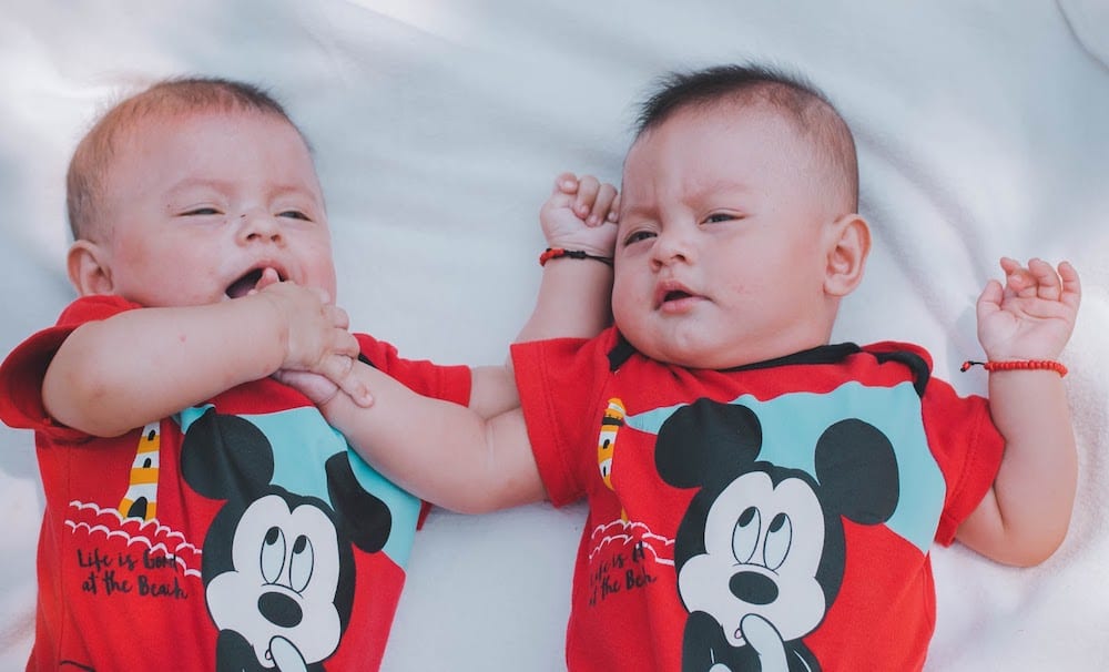 Two Babies Wearing Red Mickey Mouse Shirts 2132663