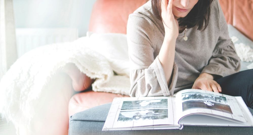 A woman looks through a photo album