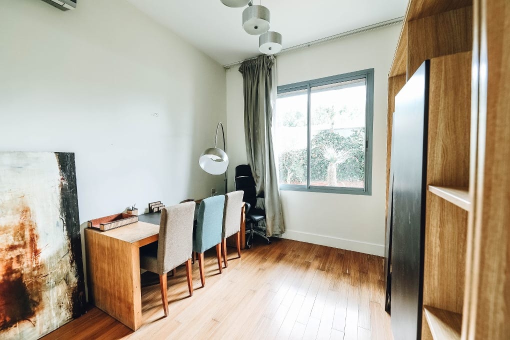 A room with a study and three chairs