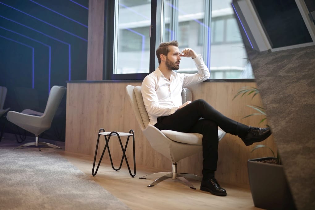 A person sits by the window in contemplation