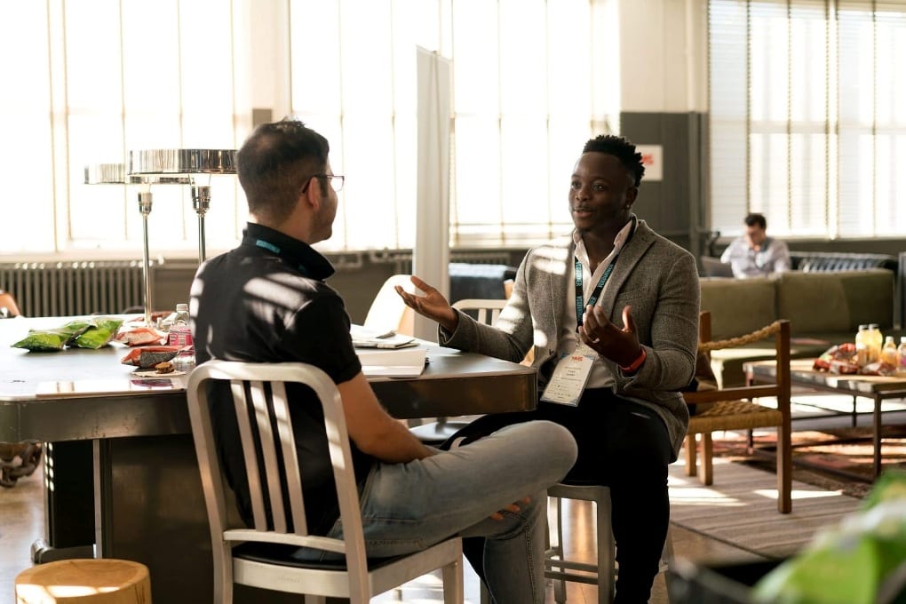 Two men talking at work