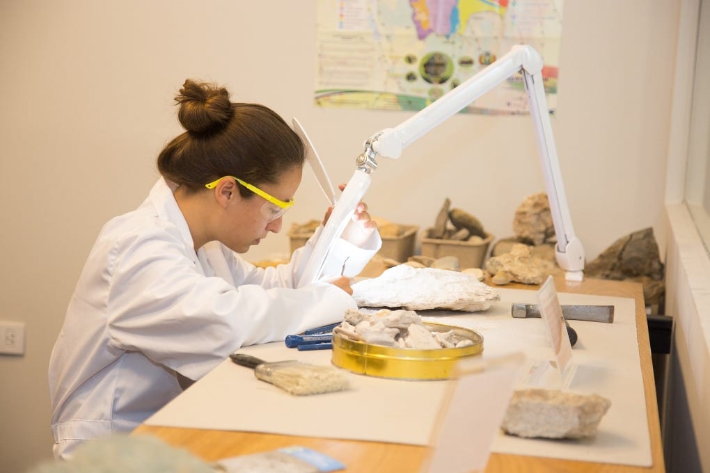 female scientist at table