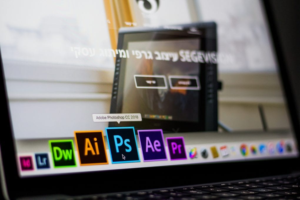 A laptop screen showing Adobe applications