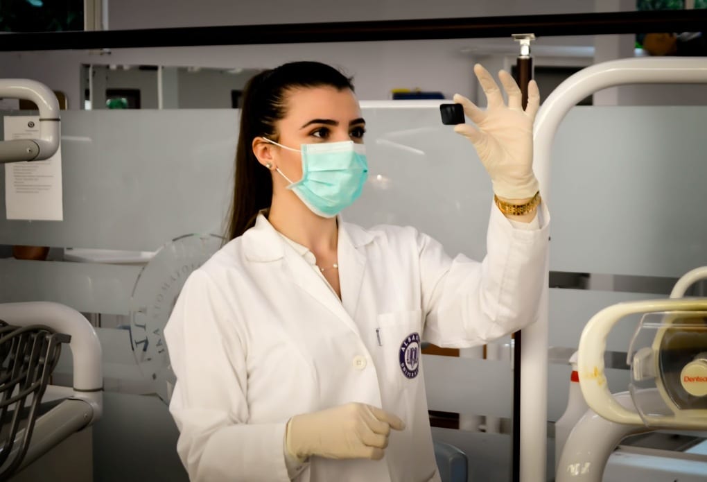 A doctor examining a lab specimen