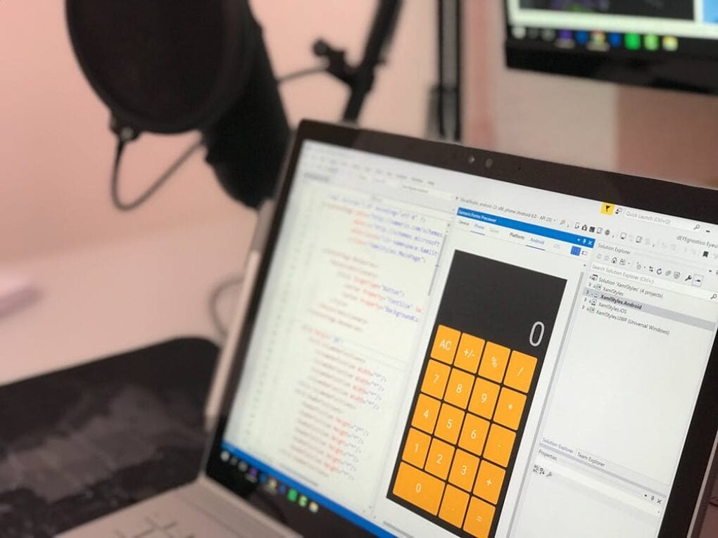 A laptop screen with a calculator and HTML script