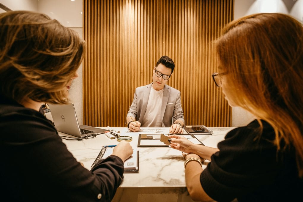 A photo of three people at work.