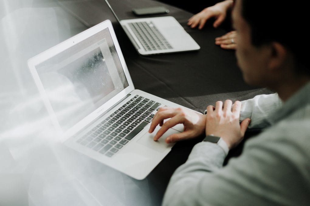 man in suit on laptop
