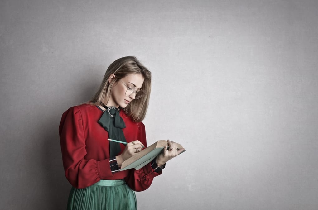 Woman in red reading book
