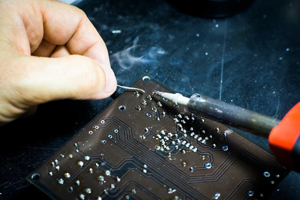 A person soldering a chip. 