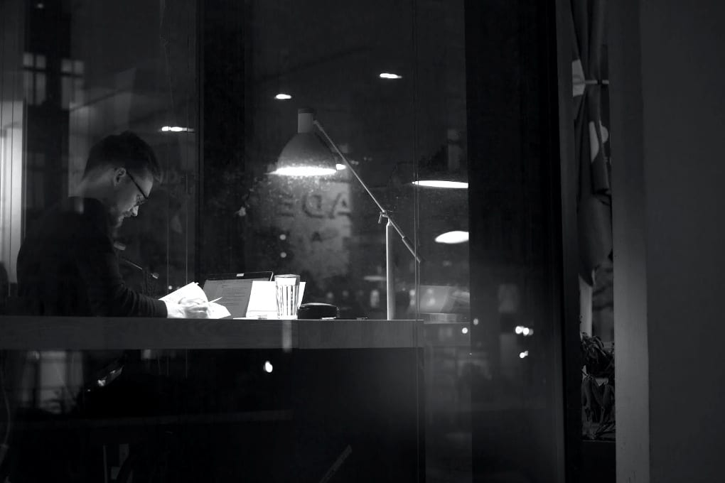 A young man studying in a coffee shop. 