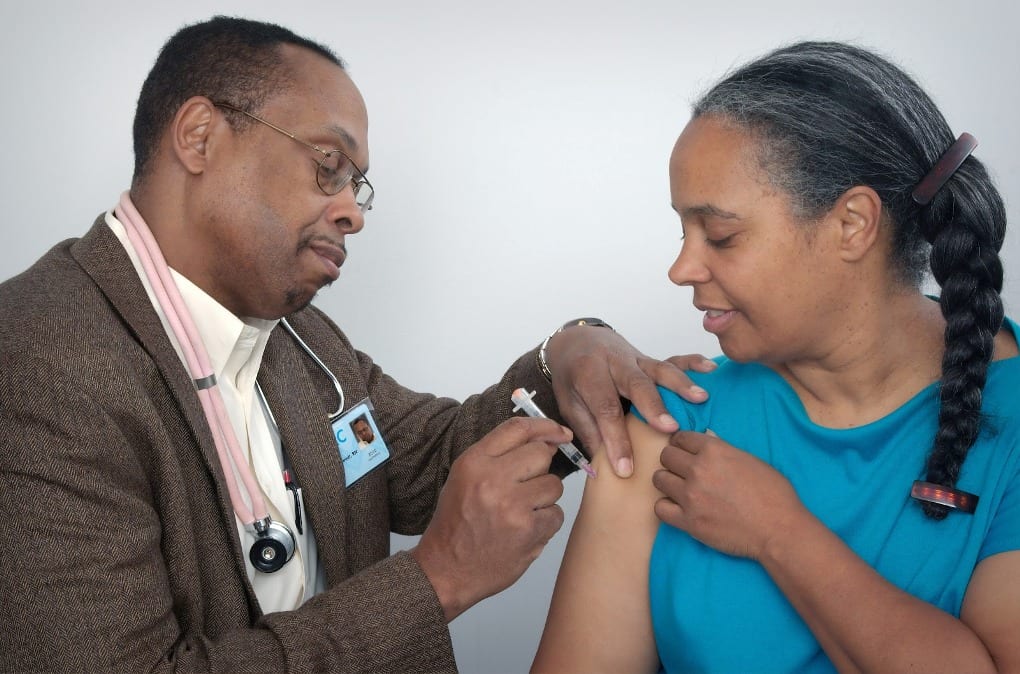 a doctor providing an injection to a patient