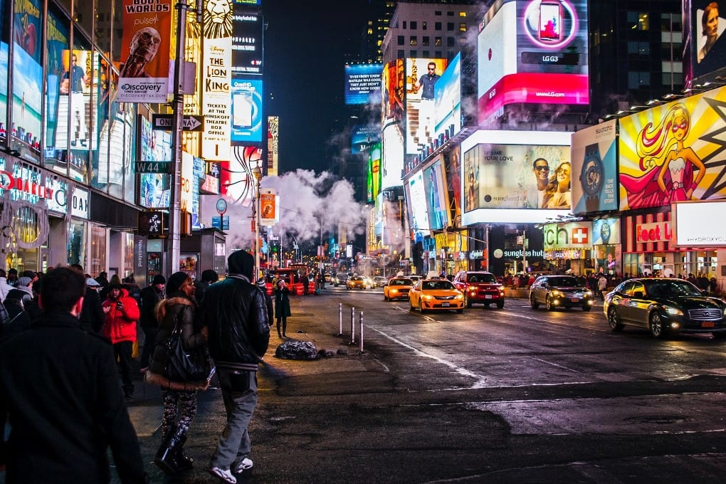 Times Square at night with bright lights from the adverts