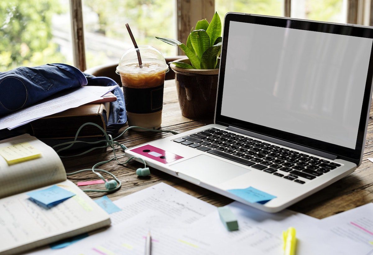  Laptop and coffee on desk with Post-It notes Online Excel Courses, Classes, and Training 