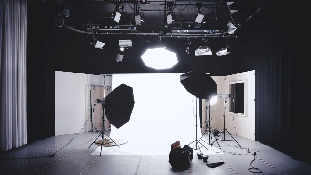 a wooden photography studio with light boxes and a white backdrop