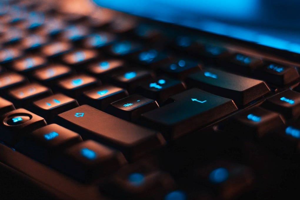 A Windows keyboard with blue lights on the keys