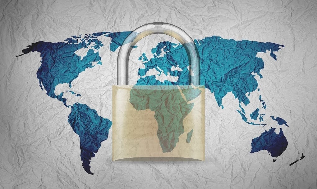 Two-dimensional map of the world on crumpled paper, with all of the continents in blue and the oceans in white, overlaid with an image of a translucent gold padlock. 