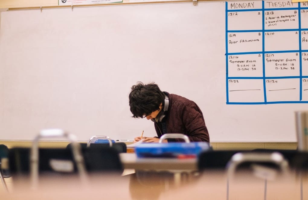 A student taking an exam in the classroom
