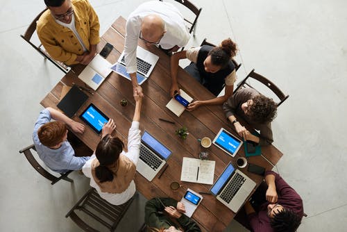 a group of employees sitting around a table and working