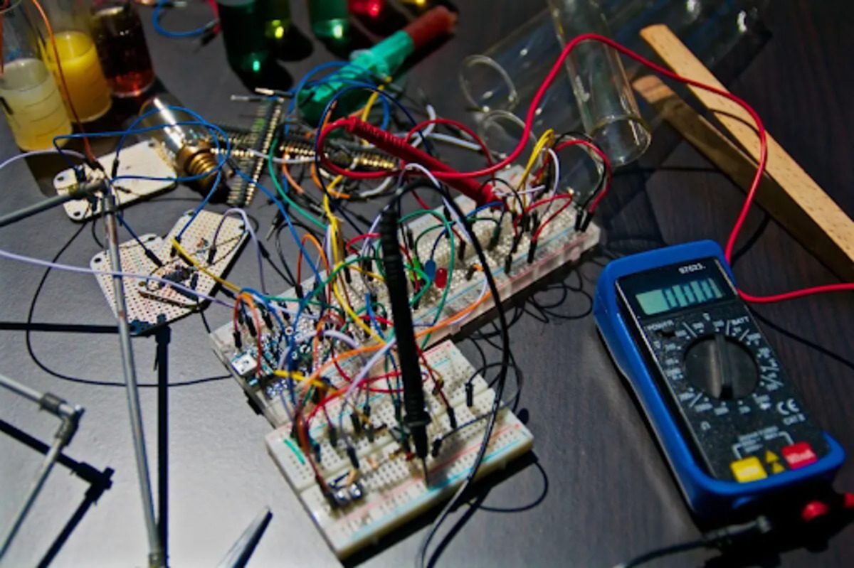 An image of several circuit boards with wires on a table.