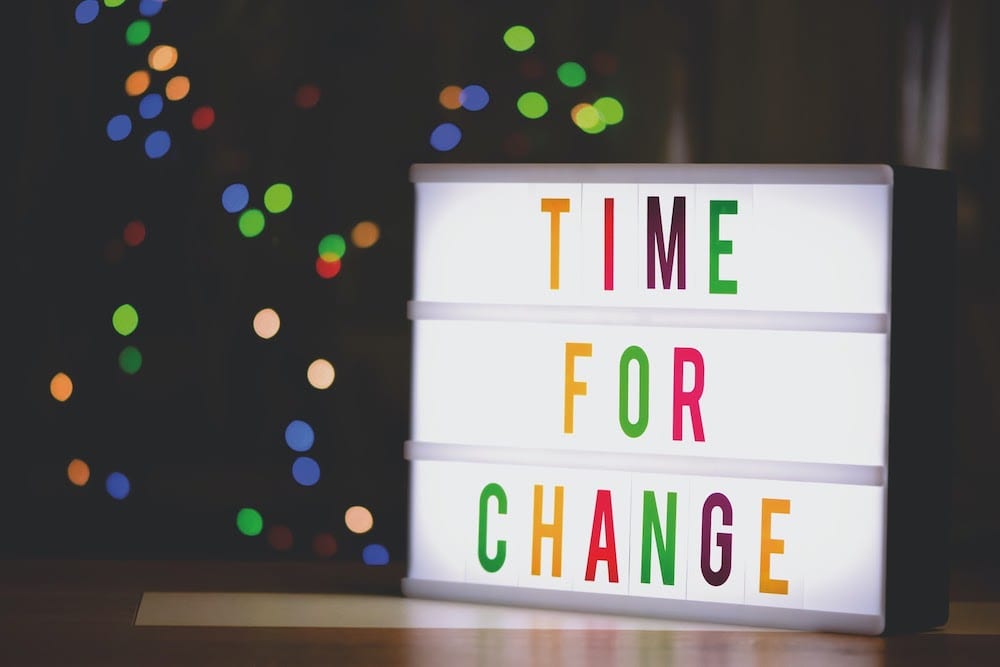 Sign with led lights spelling out the words “time for change.”
