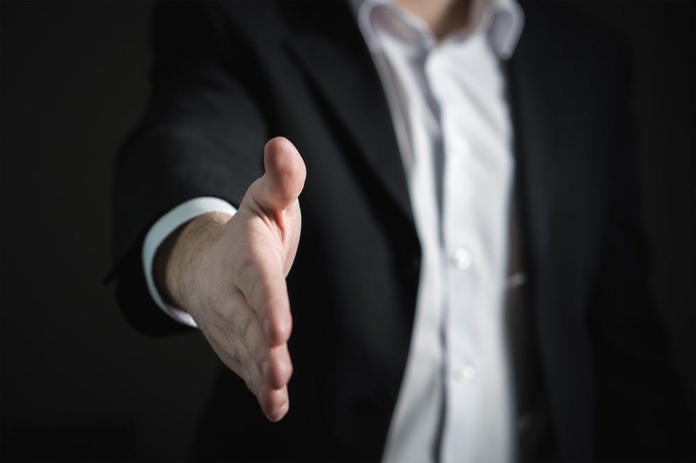  A man puts out his hand for a handshake.