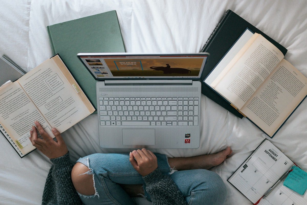 A person studying in bed how to become a data architect