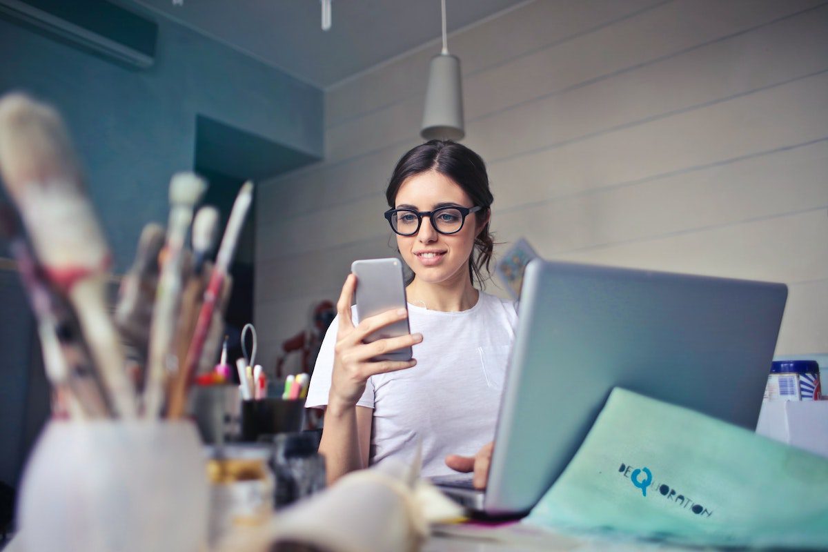 : A woman in a white shirt staring at an iPhone how to become a quantitative analyst