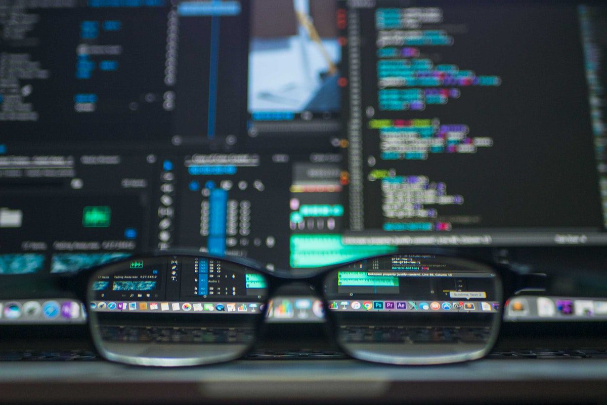 A pair of glasses on a laptop displaying code Database Management Master's Degrees