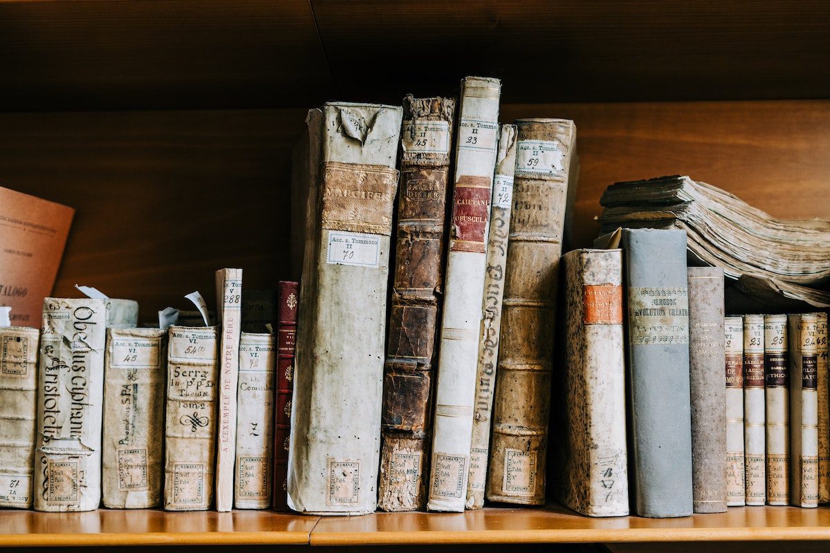 Old books stacked on a shelf. jobs for english majors