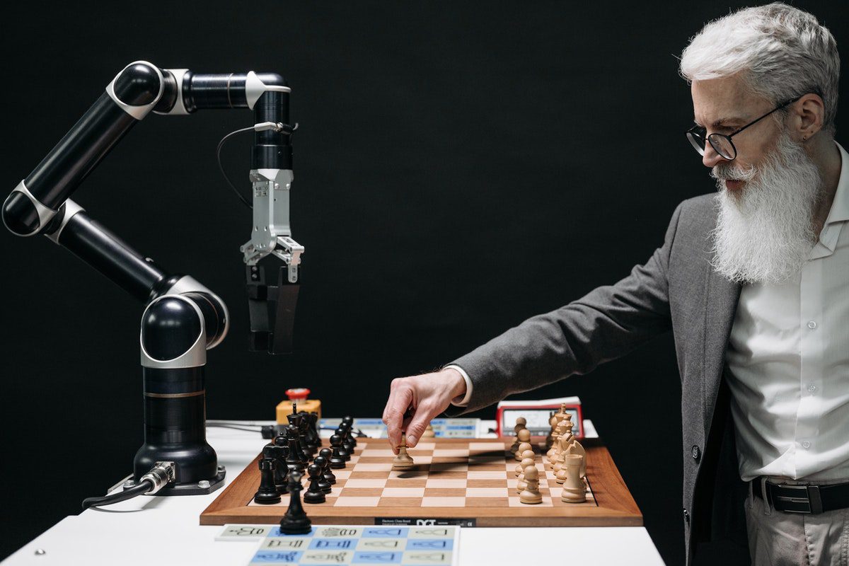 A man playing chess with a robot. Artificial Intelligence Apprenticeships
